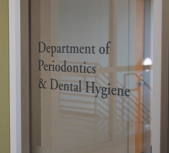 Exterior window sign for the Department of Periodontics and Dental Hygiene.