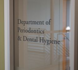 Exterior window sign for the Department of Periodontics and Dental Hygiene.