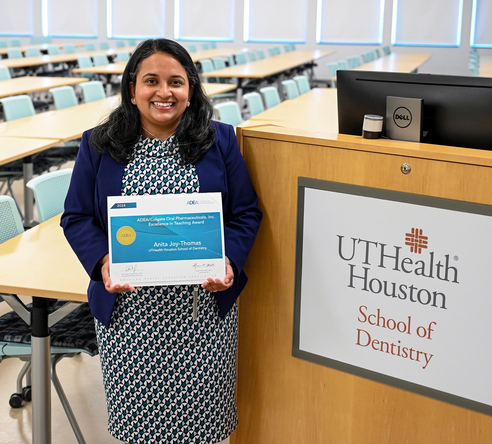 Dr. Anita-Joy Thomas holds her 2024 American Dental Education Association/Colgate-Palmolive Co. Excellence in Teaching Award certificate.