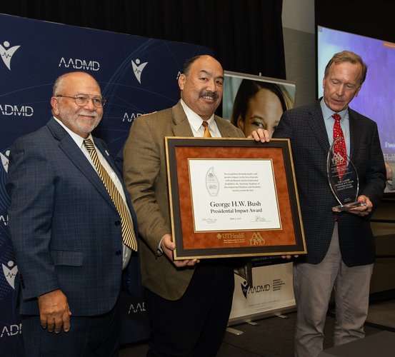 UTHealth Houston School of Dentistry and the American Academy of Developmental Medicine and Dentistry present the George H.W. Bush Presidential Impact Award to his son, Neil (right).