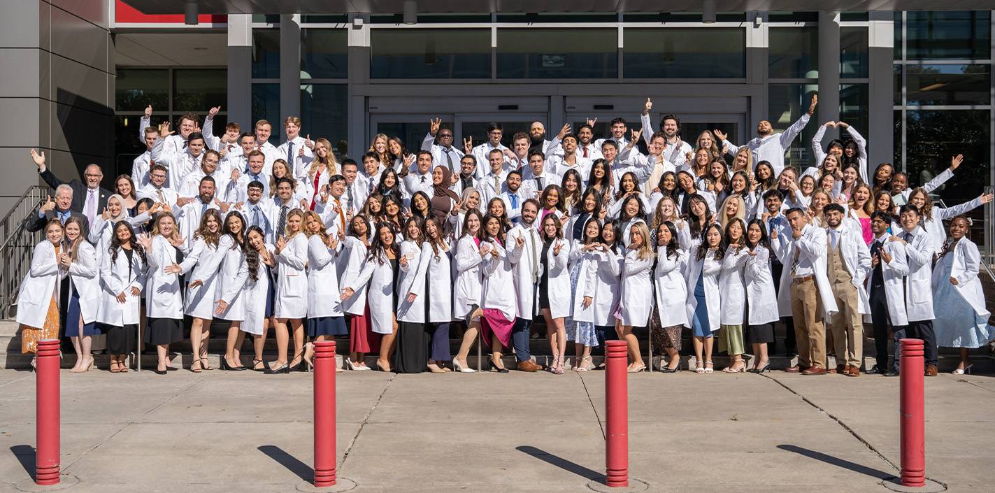 Group of dental students in a celebratory group photo.