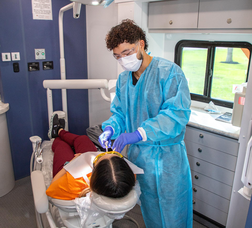 Dental hygiene student Nghiep (Lucas) Ly provides preventive dental care to a patient during a community outreach event.