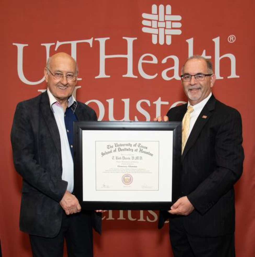 Dr. T. Bob Davis (left) being presented his Honorary Alumnus Award by Dr. John Valenza, dean of UTHealth Houston School of Dentistry.