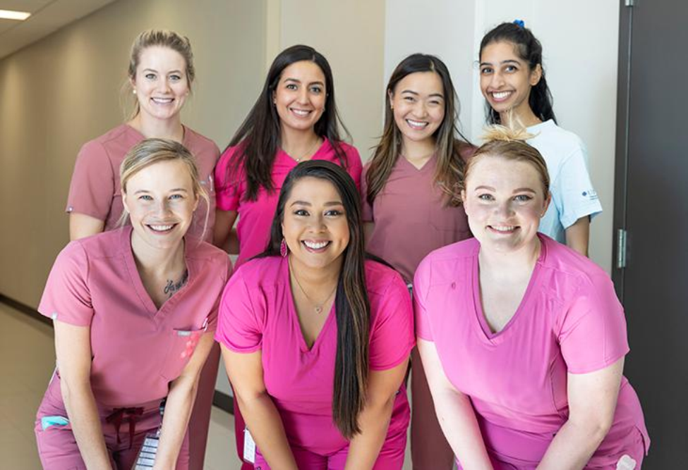 Officers of the TAWD Chapter at UTHealth Houston School of Dentistry wearing pink scrubs in recognition of National Breast Cancer Awareness Month.