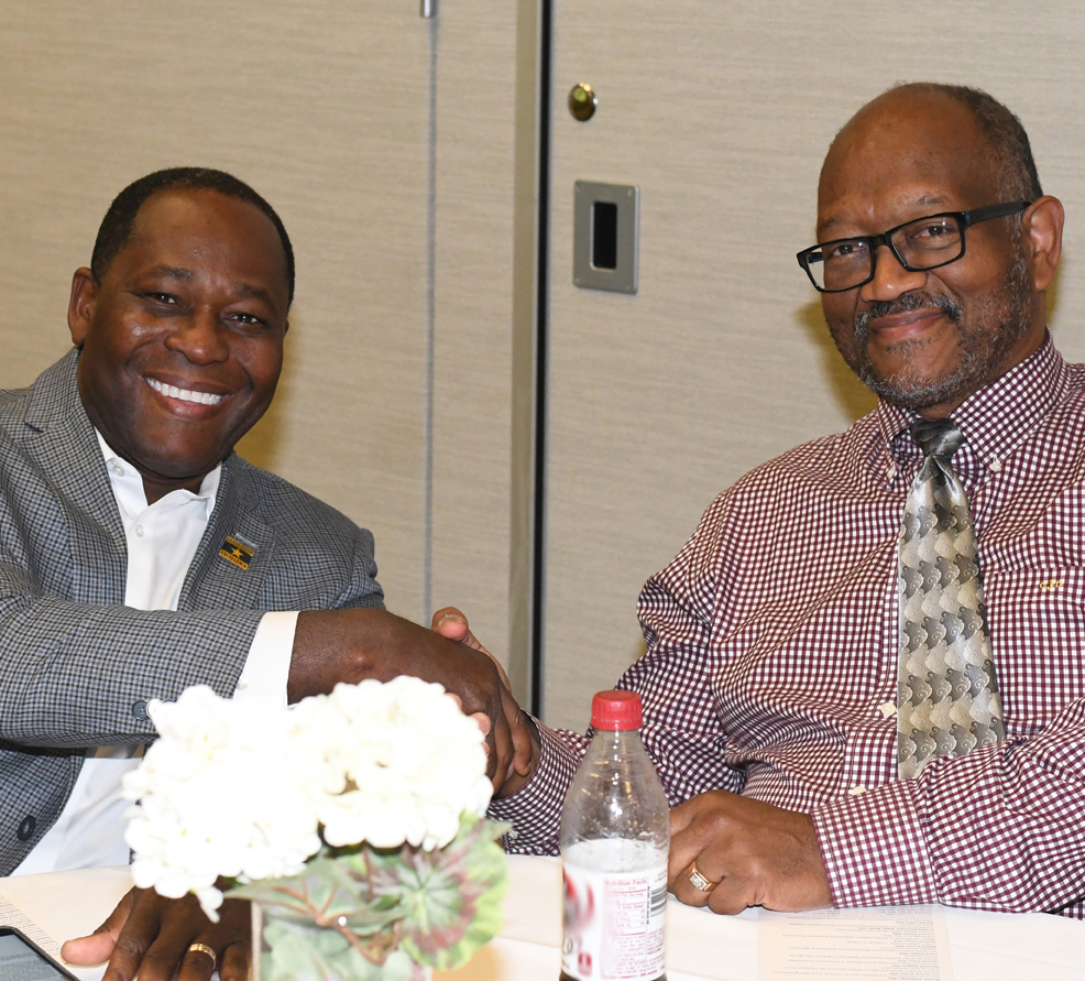 Dr. Harry Joseph (left) shakes hands with his faculty mentor, Dr. C.D. Johnson, at the AHCFP Dr. Harry Joseph (left) shakes hands with his faculty mentor, Dr. C.D. Johnson, at the AHCFP