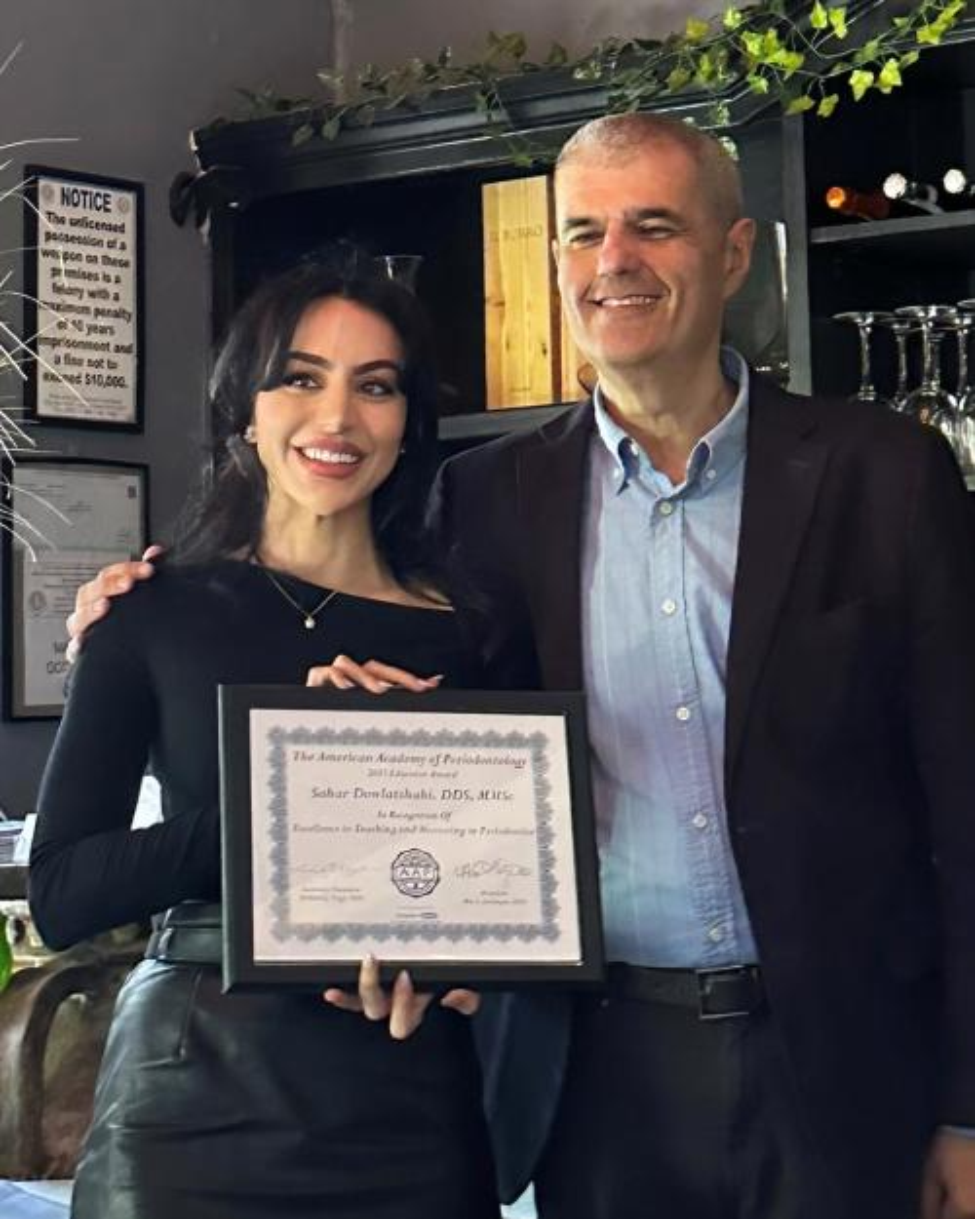Man presents women a award plaque at an event.