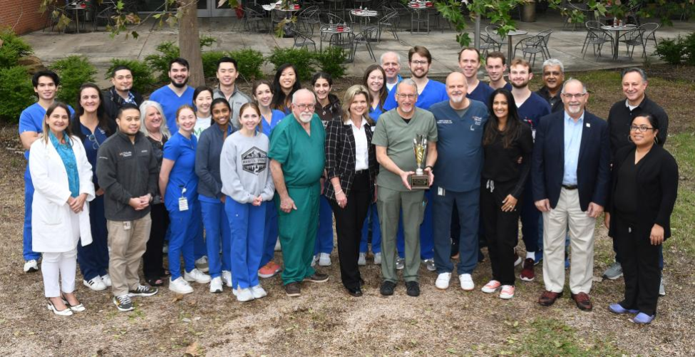 Members of the Orange Practice, Ivoclar, and Dean John Valenza, DDS, and Director of Digital Dentistry Michelle Thompson, DDS, gather for a photo with the Digital Dentistry Practice of the Year trophy.