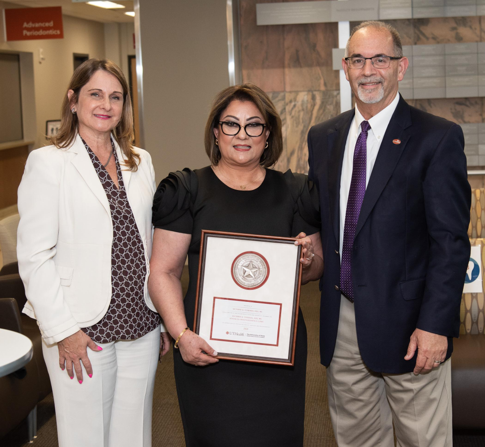 Dr. Victoria Cisneros (middle) stands with Dr. Maria A. Loza (left), Department of Restorative Dentistry and Prosthodontics chair, and Dr. John Valenza, dean, during the Advanced Prosthodontics Clinic naming reception.
