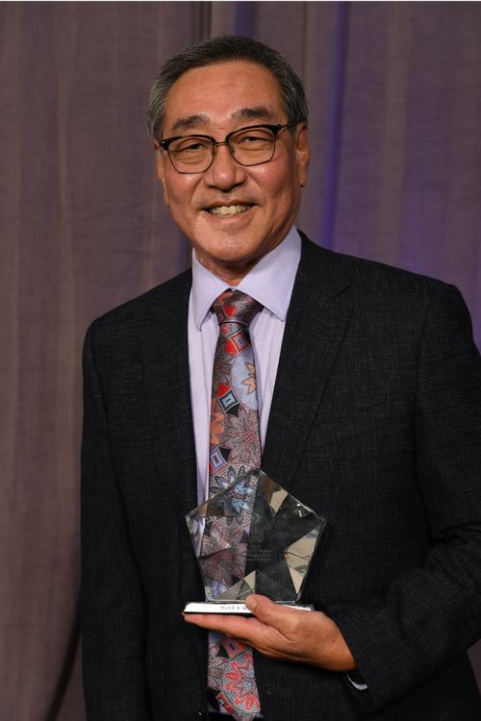 Dr. Mark Wong poses with his Robert V. Walker Distinguished Service Award.