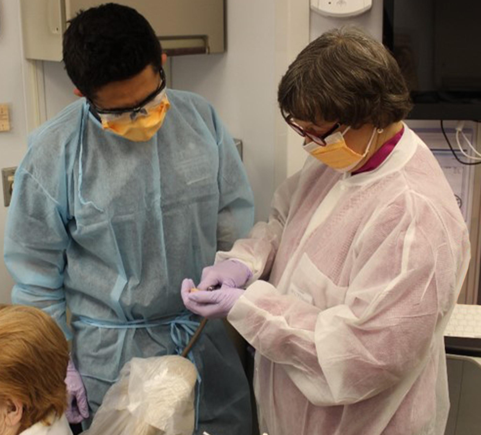 Dr. Debra Stewart (right), oversees fourth-year dental students during three-week rotations on UTSD’s adult dental van.