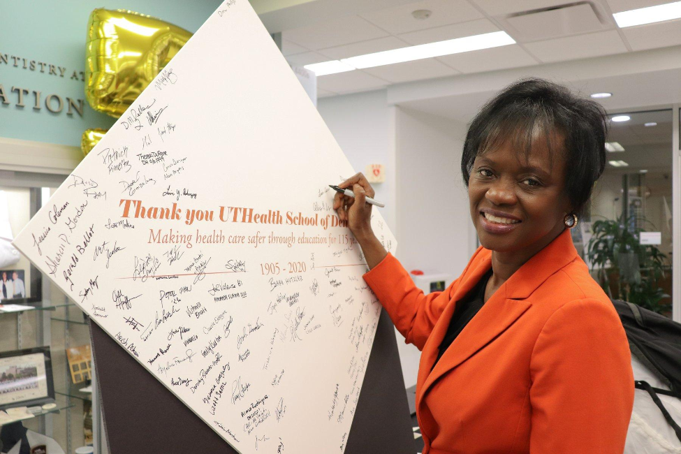 Lisa Cain, PhD signed her name on a 3-foot-wide signature board.