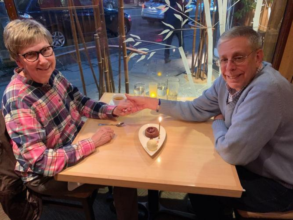 Husband and wife, John and Susan Powers, pose for a photo while at dinner. Husband and wife, John and Susan Powers, pose for a photo while at dinner.