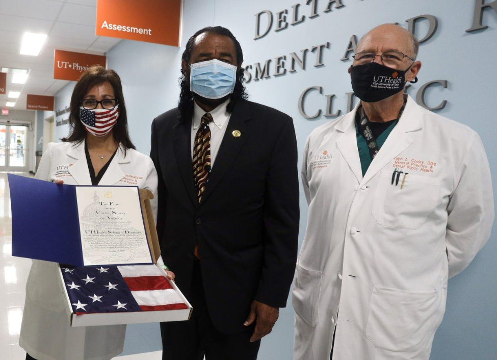 Congressman Al Green (center) presented veterans with a U.S. flag to thank them for their service. Green is pictured with Drs. Margo Melchor (left) and Ralph Cooley.