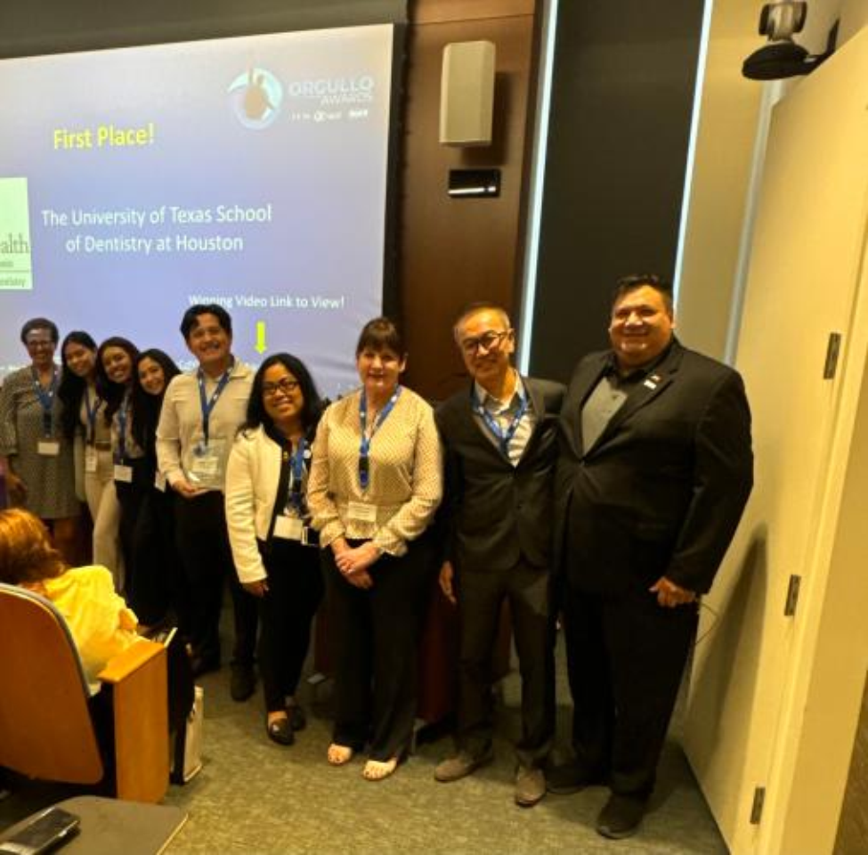 Group photo of people at the front of a lecture room.