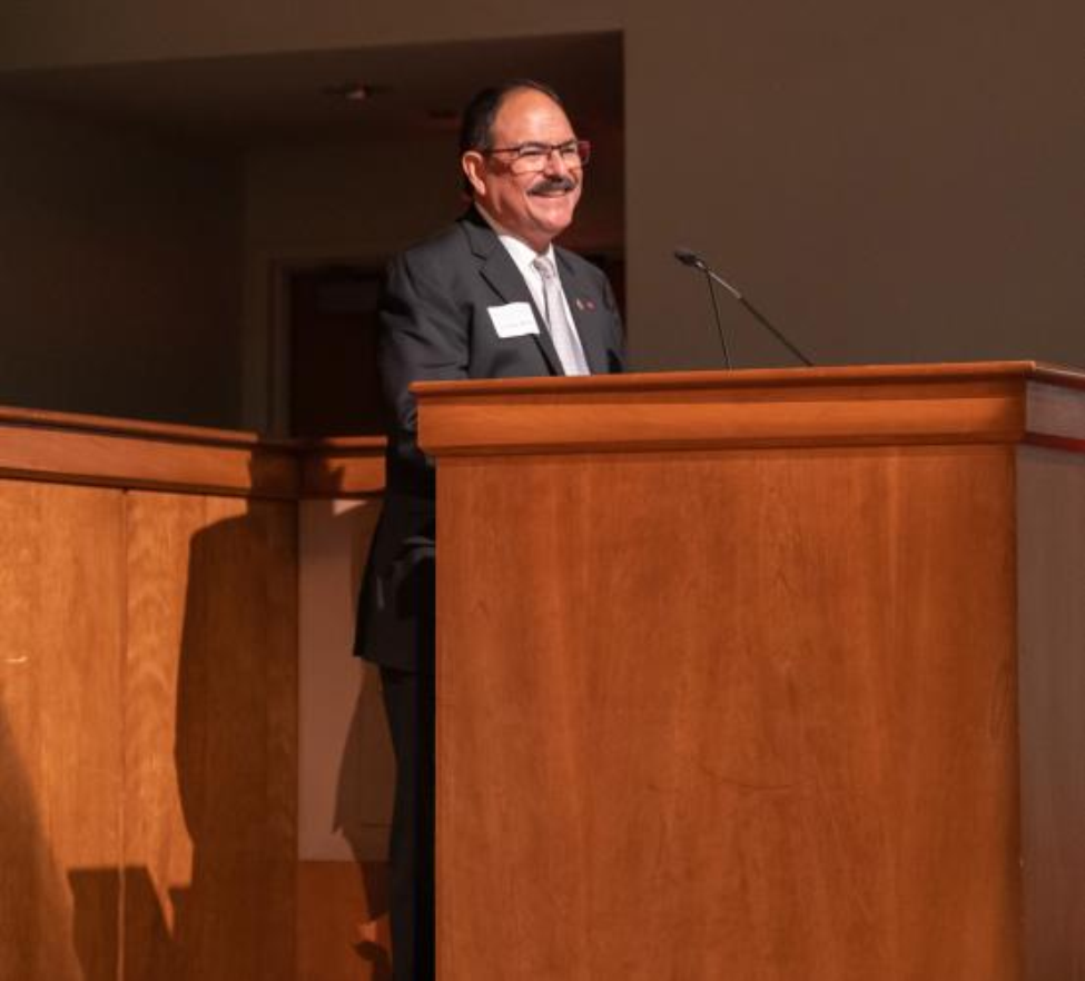 Man stands at a podium.