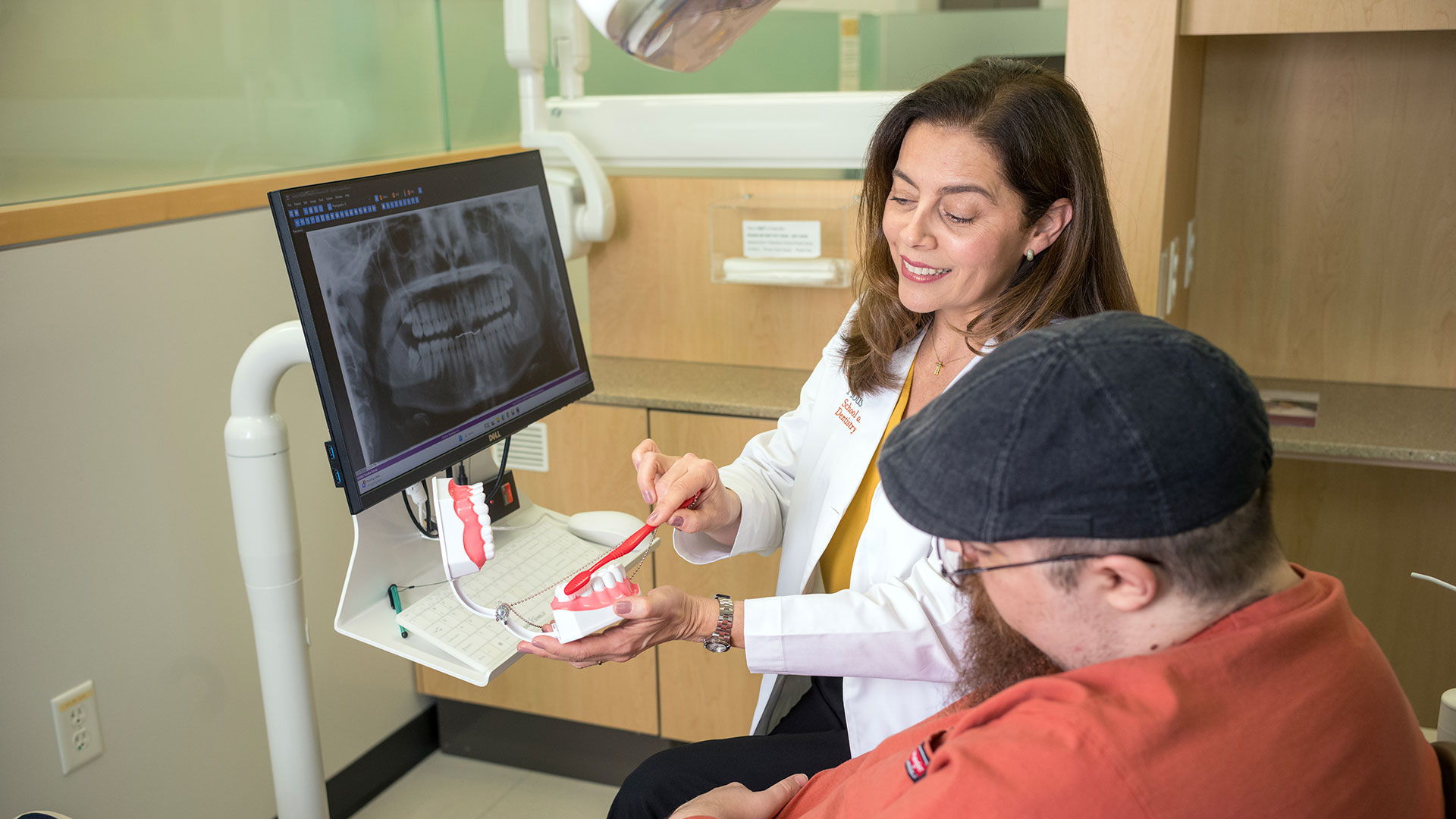 dentistry discussing proper brushing techniques with a patient